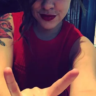 a woman making a peace sign