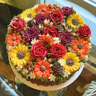 Basketweave cake overflowing with flowers. 12" 3 layers.