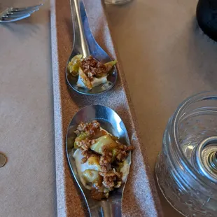three spoons of food on a table