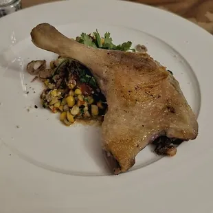 Crispy Skin Duck Confit with charred street corn, tomato jam, and cotija