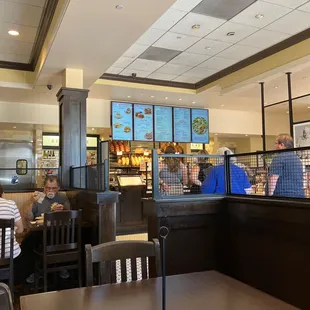people sitting at tables in a restaurant