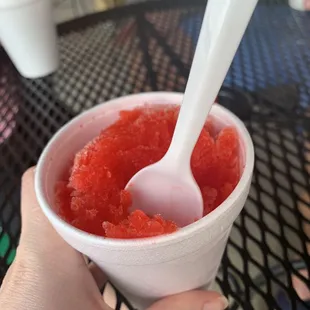 a hand holding a spoon