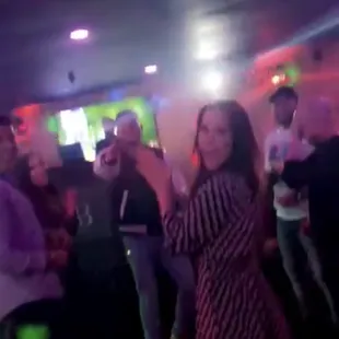 a group of people dancing at a party