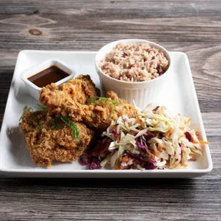Fry chicken served with Rice and peas raw veg &amp; plantain &amp; festival along with homemade sauce.