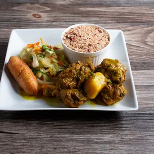 Curry chicken served with rice peas or steam rice cabbage plantains &amp; festival