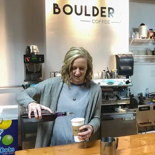 a woman pouring a cup of coffee
