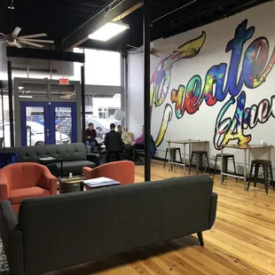 a large mural on the wall of a coffee shop