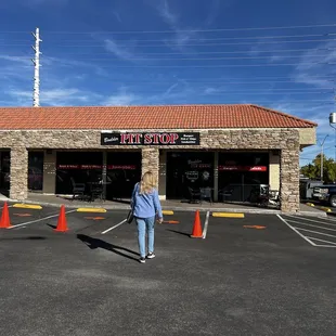 a woman walking in front of a store