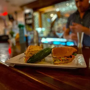 a sandwich and cucumber on a plate