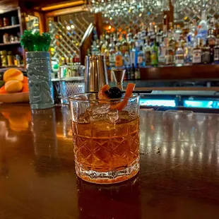 a glass of whiskey on a bar