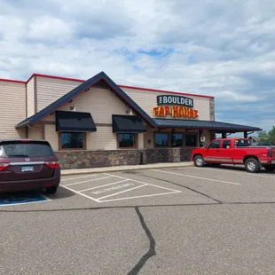 a red truck parked in front of the restaurant