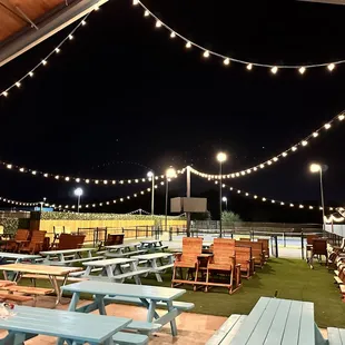 tables and benches with string lights
