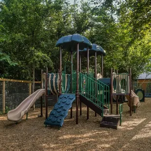 a playground with a slide and a play structure
