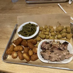 Chopped barbecue with green beans, fried okra, and hush puppies