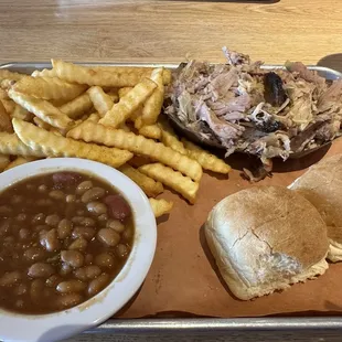 Pork platter with fries, beans and rolls