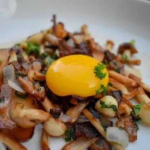 a plate of food with an egg on top