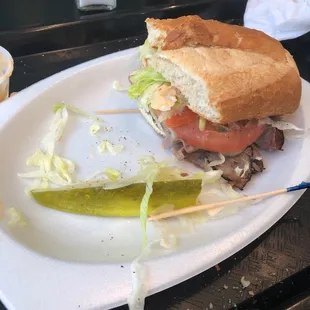 a sandwich and pickle on a plate