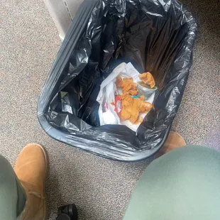 a trash can with food in it