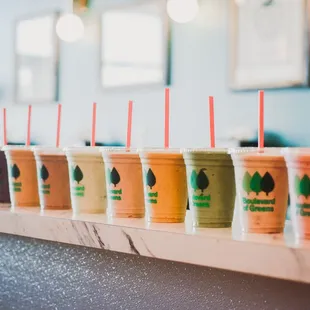 a row of smoothie drinks