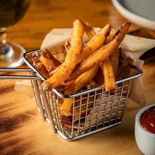 a basket of french fries with ketchup