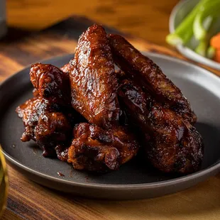 a plate of wings and a glass of beer