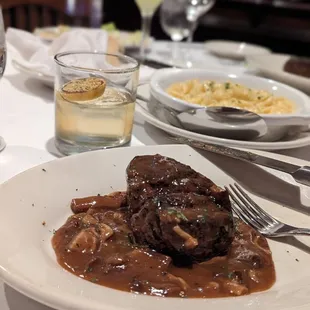 a plate of steak with mushroom gravy