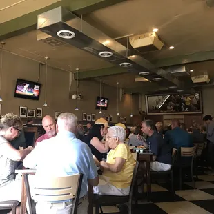 people sitting at tables in a restaurant