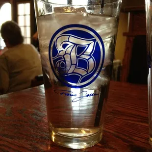a pint glass with a logo on it