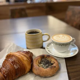 a cup of coffee and a croissant