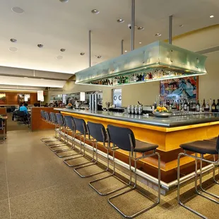 a restaurant with a bar and chairs