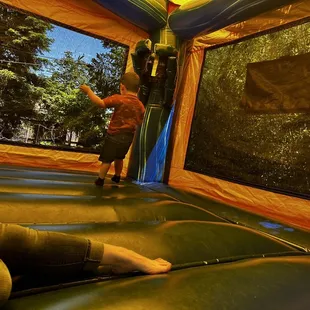 Inside bounce house with basketball hoop.