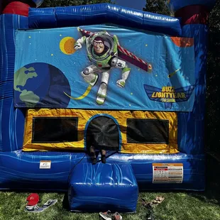Bounce house with detachable Buzz Lightyear Banner.