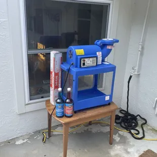 Snow cone machine came with 2 syrups (got to pick from 3) and cups. You provide your own ice.