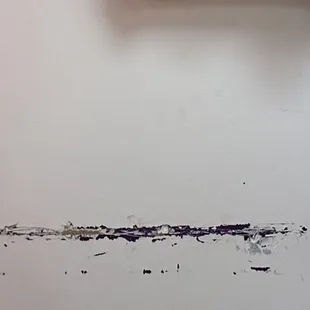 It's not just dirty, the wall is damaged