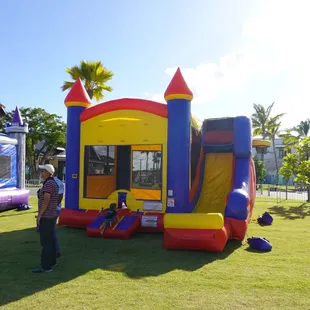 Bright colorful bounce house with a large slide!