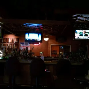 a bar with people watching tvs