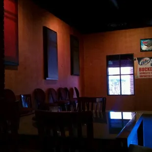 a table and chairs in a dimly lit room