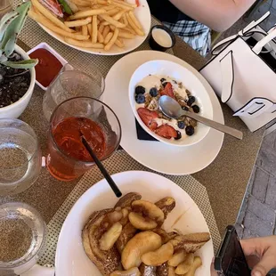 a plate of french fries and a bowl of salad