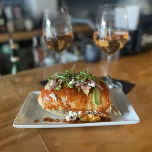 a plate of food and two glasses of wine