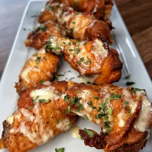 Dry rubbed jumbo party wings served in an Alabama White
BBQ sauce