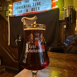 a glass of beer on a bar