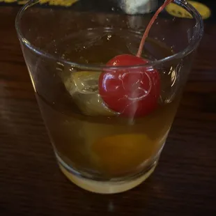 a drink with a cherry on top