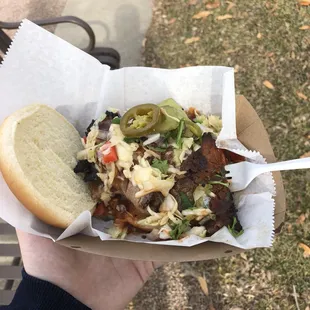  hand holding a sandwich