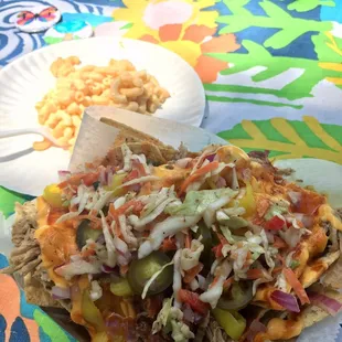  plate of nachos with a side of macaroni and cheese