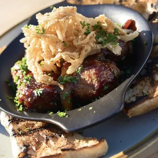 Bourbon Balls - peaches and meatballs flambéed with bourbon, bbq sauce, crispy onions &amp; bread