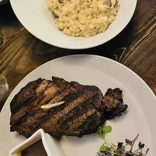 Dry aged steak with mushroom risotto and bourbon Demi-glacé sauce on the side.