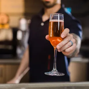 a man holding a glass of beer