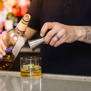 a bartender pouring a drink