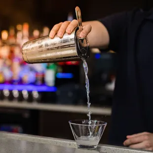 a bartender pouring a drink