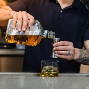 a bartender pouring a drink